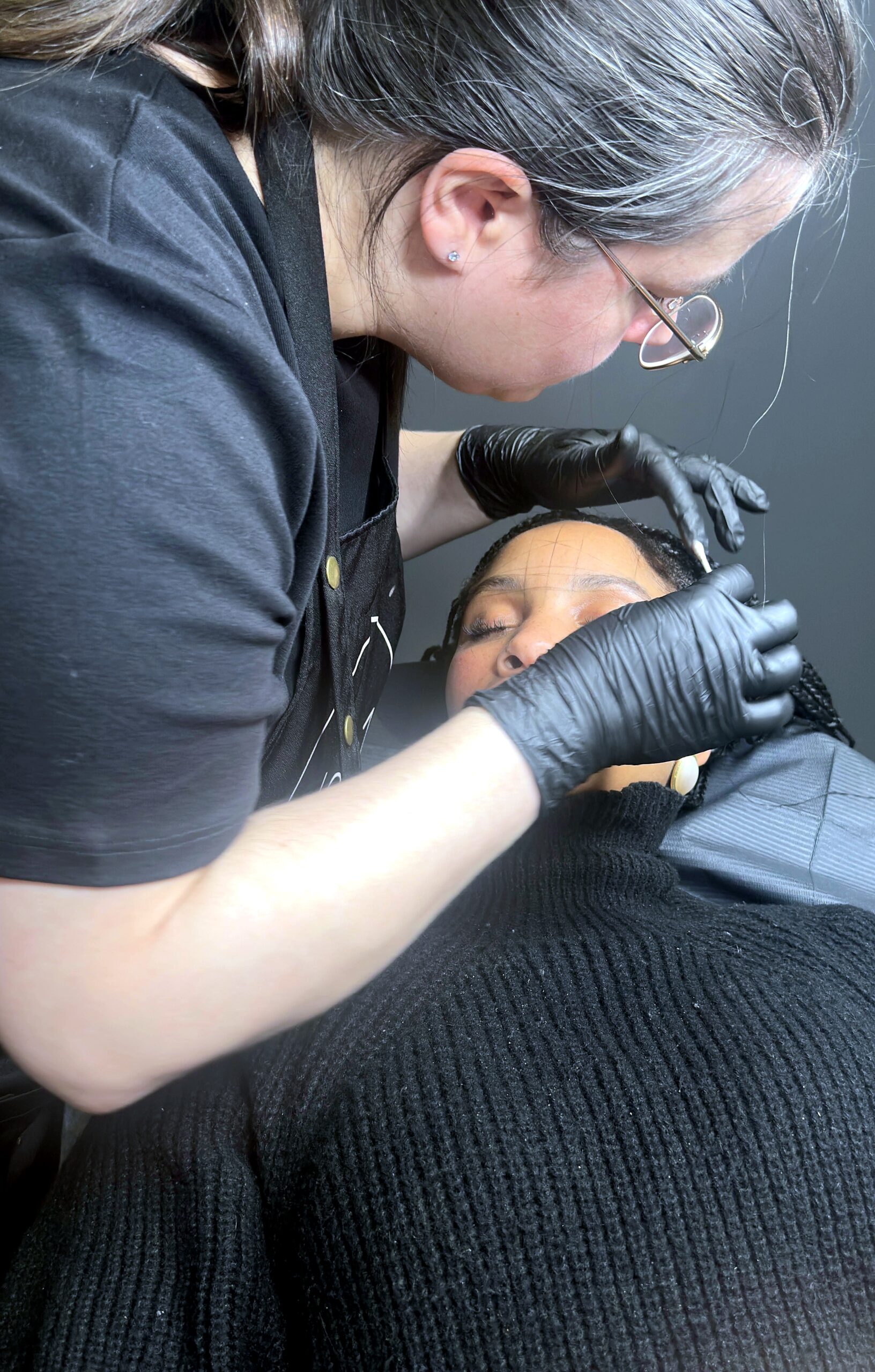 Agnes brow-mapping a client before permanent makeup application